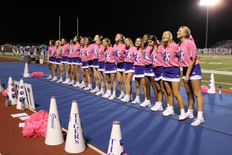 High school athletes support breast cancer awareness with pink